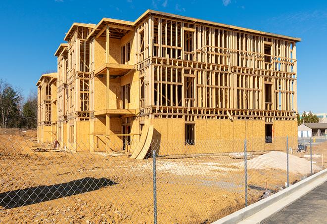 a temporary chain link fence winding around a construction site, outlining the project's progress in Azusa, CA